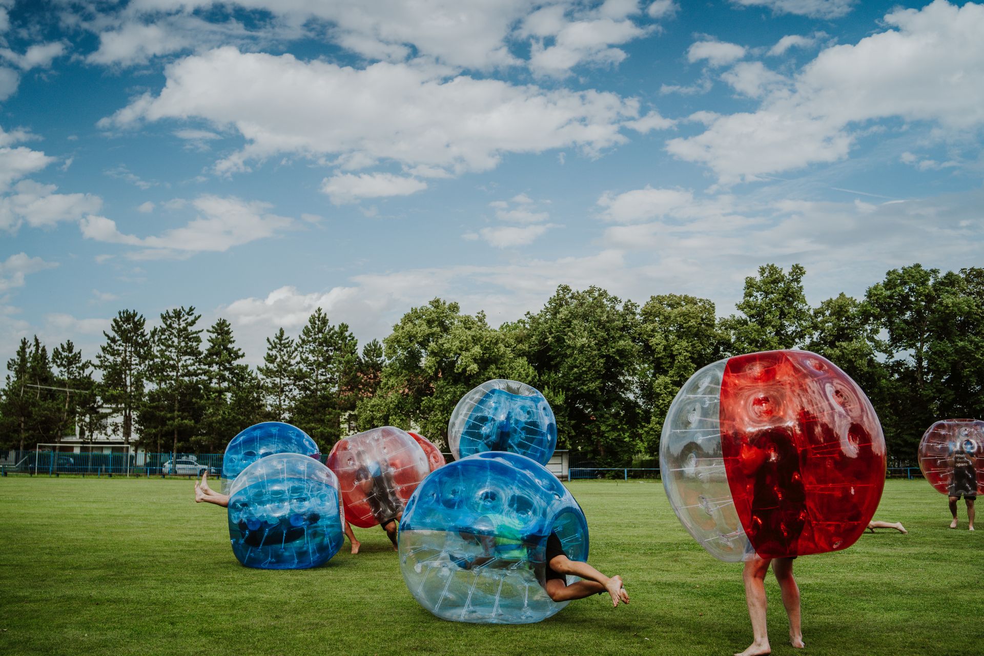 People playing in Bubble Football. Zorbing bumper football socce